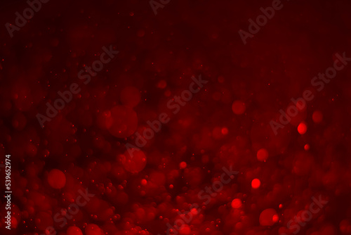 Red glitter vintage lights background. red bokeh shiny on dark background.