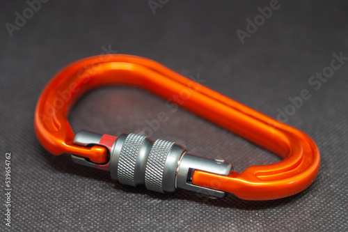 Strong carabiner for climbing and mountaineering on a black background
