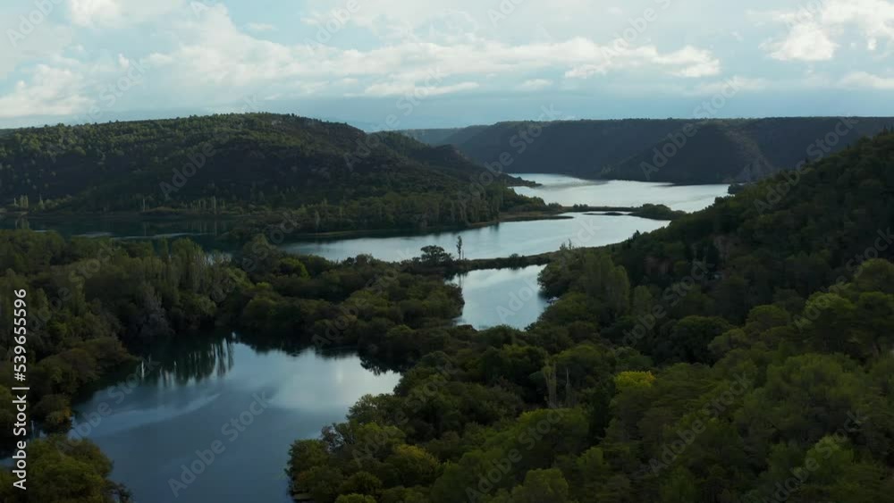 Krka River is a beautiful natural wonder in Croatia, known for its dramatic waterfalls and lush vegetation. This aerial footage shows off the river's stunning landscapes and forests. Krka River is a beautiful natural wonder in Croatia, known for its dramatic waterfalls and lush vegetation. This aerial footage shows off the river's stunning landscapes and forests.