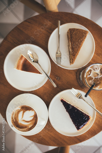 Desserts and coffee on wooden table. © polinaloves