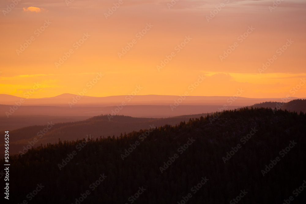 Mountainous landscape during colorful sunset in Northern Finland 