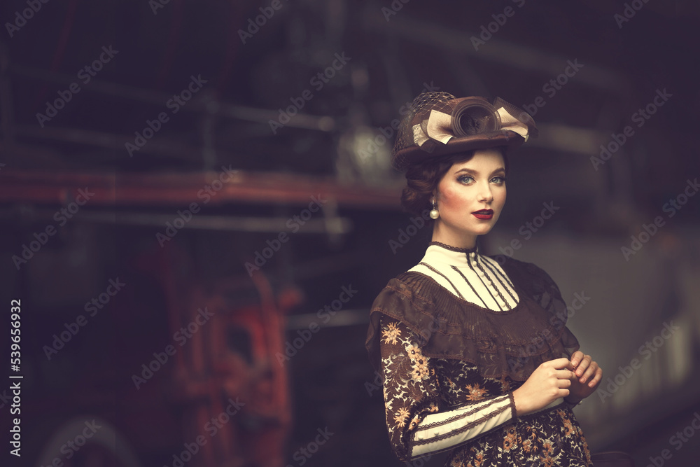 Beautiful girl in a historical retro dress on a background of an old steam locomotive, steampunk, at the railway station. Beautiful girl in a historical retro dress on a background of an old steam locomotive, steampunk, at the railway station.