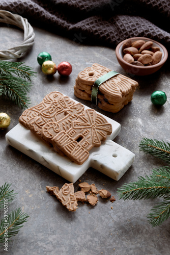 Speculoos or Spekulatius, Christmas biscuits, chocolate balls and almonds on a table with fir twigs. Traditional German sweets, cookies for Christmas or Advent, wintertime snacks.