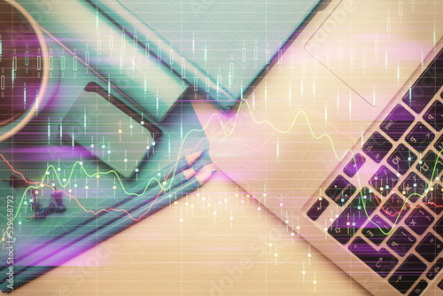 Double exposure of forex graph drawing over desktop background with computer. Concept of financial analysis. Top view.