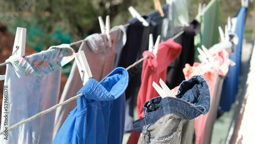 Kids dresses drying on clothes line during a sunny day,hygiene housekeepeng family lifestyle photo