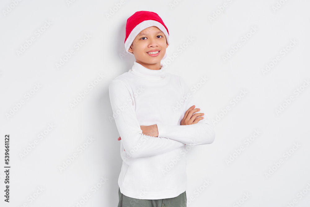 Portrait of smiling Asian man in christmas hat crossed arms and looking at camera with confident isolated on white background Portrait of smiling Asian man in christmas hat crossed arms and looking at camera with confident isolated on white background