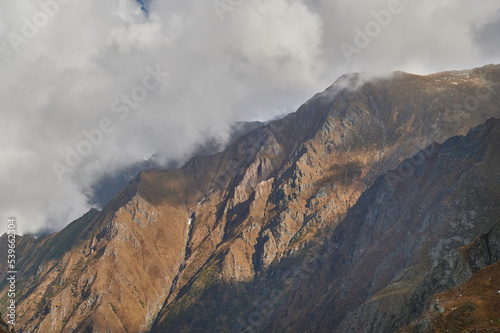 Landscape of a mountain ridge touched by the the stormy sky