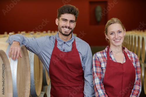 portrait of two adult workers in wine factory