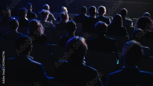 Wallpaper Mural Audience Full of Tech People in Dark Conference Hall Watching an Innovative Inspiring Keynote Presentation. Business Technology Summit Auditorium Room Crowded with Delegates. Static Shot from Behind. Torontodigital.ca