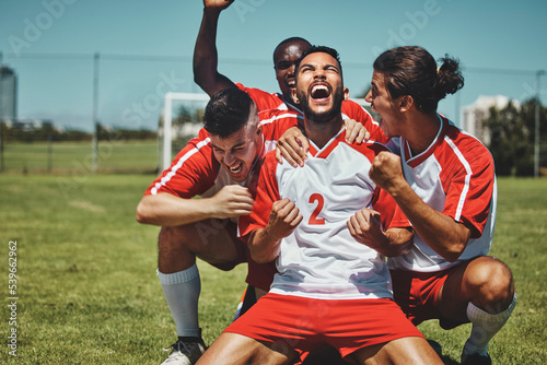 Fototapeta Naklejka Na Ścianę i Meble -  Success, happy team or winner for soccer player celebration during match at soccer field, stadium or sport workout. Teamwork, achievement or friends for fitness goal, wellness or football exercise.