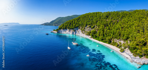 Panoramic landscape view of the beautiful coast of Skopelos island with turquoise sea at pristine beaches and thick pine forest, Sporades, Greece