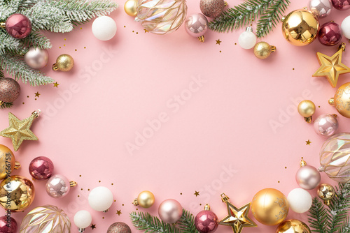 Christmas concept. Top view photo of stylish transparent white gold and pink baubles star ornaments confetti and pine branches in snow on isolated pastel pink background with blank space in the middle