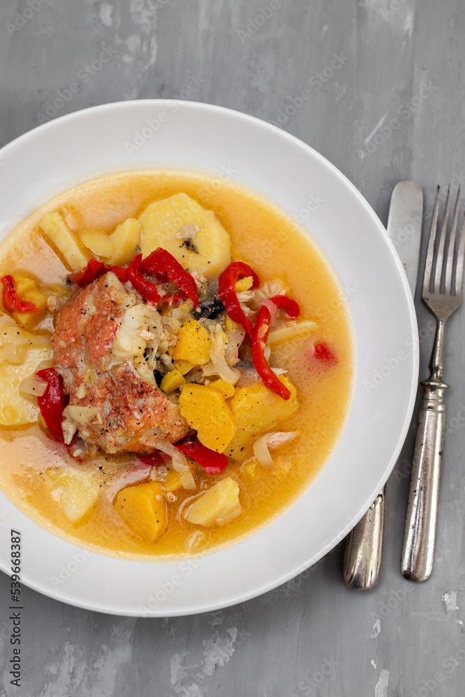 typical portuguese fish stew on white plate on ceramic