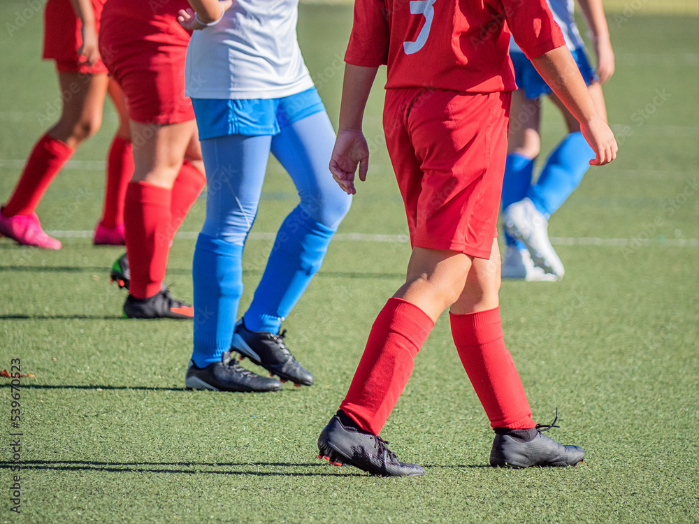 unrecognizable legs of a young team soccer player unrecognizable legs of a young team soccer player