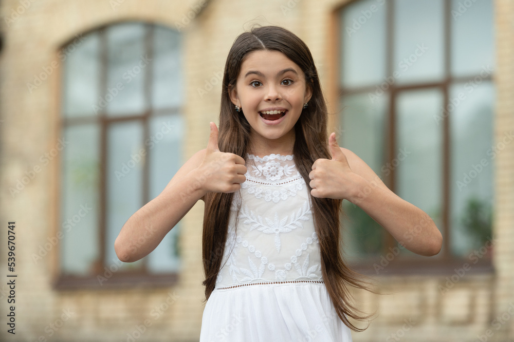 pretty teen girl. adorable girl fashion model. portrait of teenager girl outdoor. thumb up pretty teen girl. adorable girl fashion model. portrait of teenager girl outdoor. thumb up