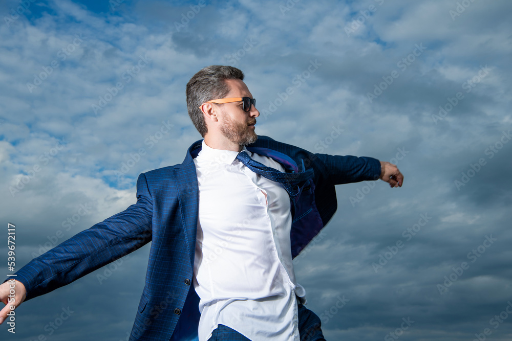 Businessman walking in open suit jacket fluttering in carefree wind. carefree businessman Businessman walking in open suit jacket fluttering in carefree wind. carefree businessman