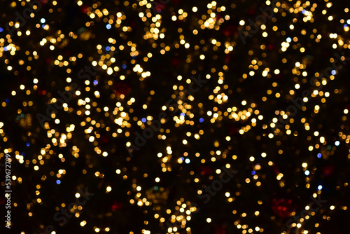 Gold and blue bokeh circles on a black background. Christmas colorful lights. Overlay