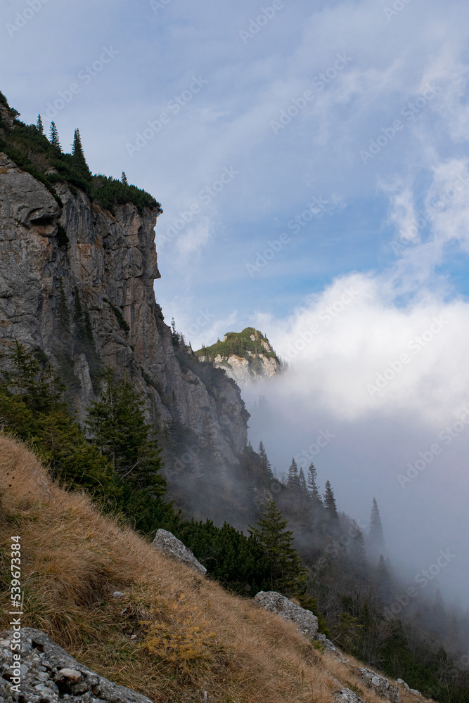 Scenic autumn morning on mountains hills with fog. Fall panoramic landscape.