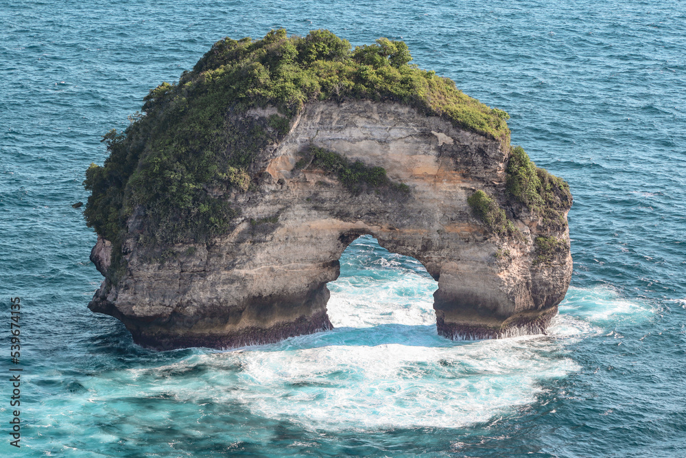 rock in arch shapes by to coast of Nusa Penida
