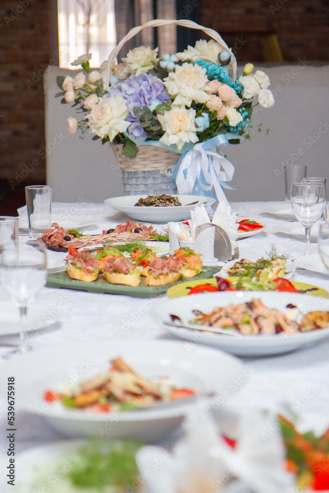 Fototapeta premium sandwiches and snacks on a table with a white table, a festive table