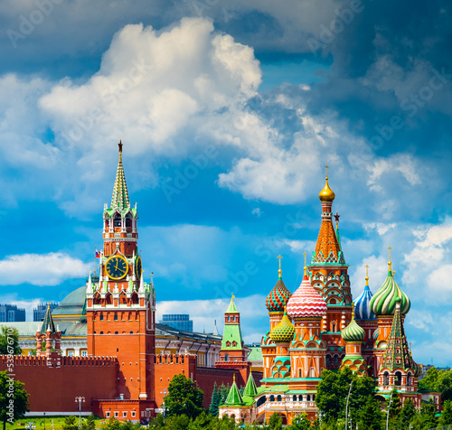 Spasskaya Tower of Moscow Kremlin and Cathedral of Vasily the Blessed (Saint Basil's Cathedral) on Red Square in summer sunny day before the rain. Moscow. Russia