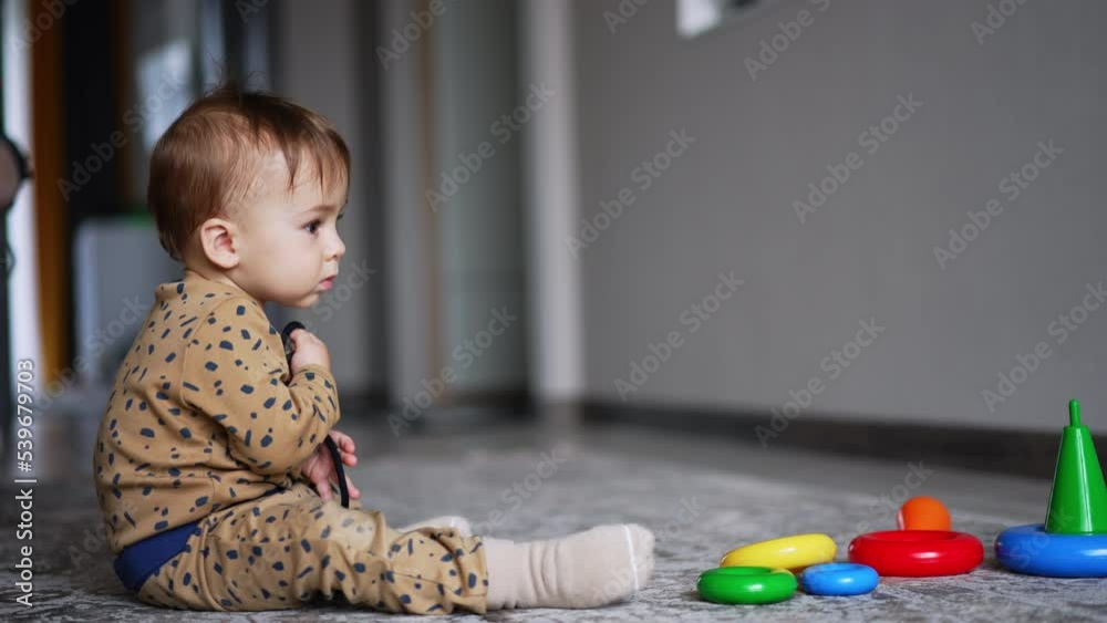 Pretty cute boy sitting with toys. Funny little child with colorful toy. Pretty cute boy sitting with toys. Funny little child with colorful toy.