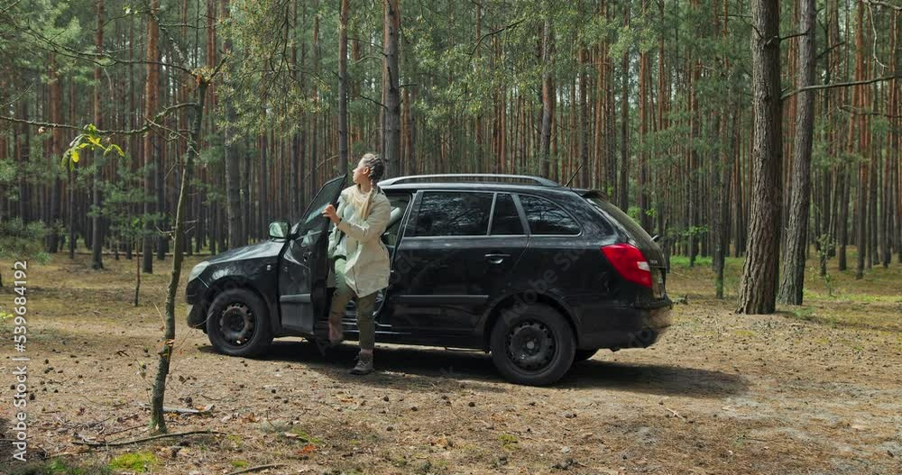 Happy relaxed young mother girl lady arrived in forest relaxing after hardworking days in city opening car taking baclpack from. Happy relaxed young mother girl lady arrived in forest relaxing after hardworking days in city opening car taking baclpack from.