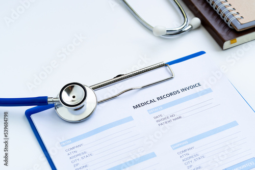 Stethoscope with medical records invoice. on white background.
