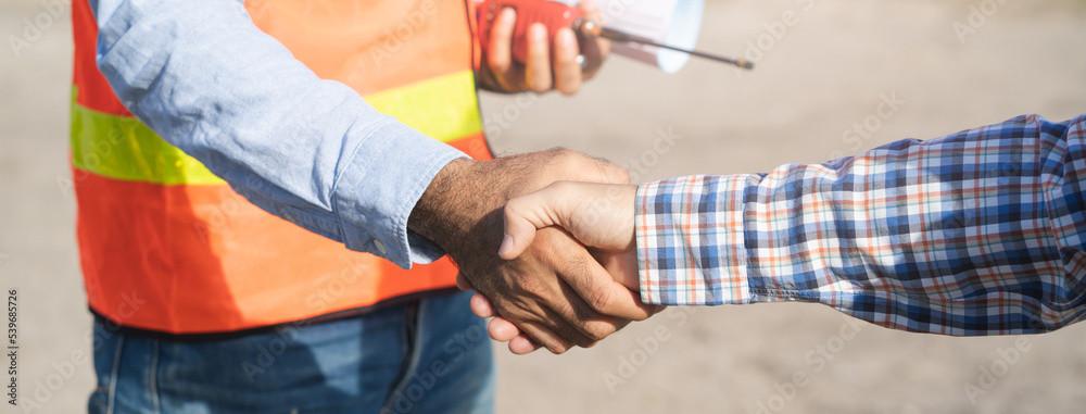 construction company handshaking with material supplier.