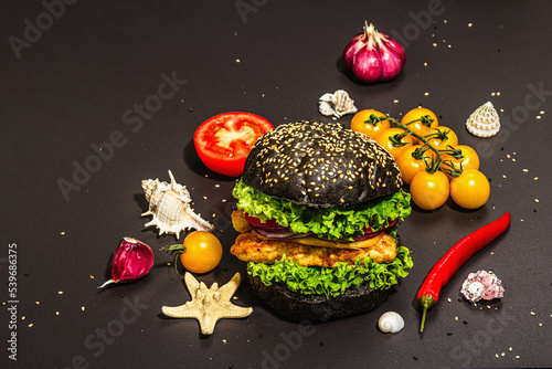 Homemade fish burger. Fresh ingredients, ripe vegetables, fast food concept