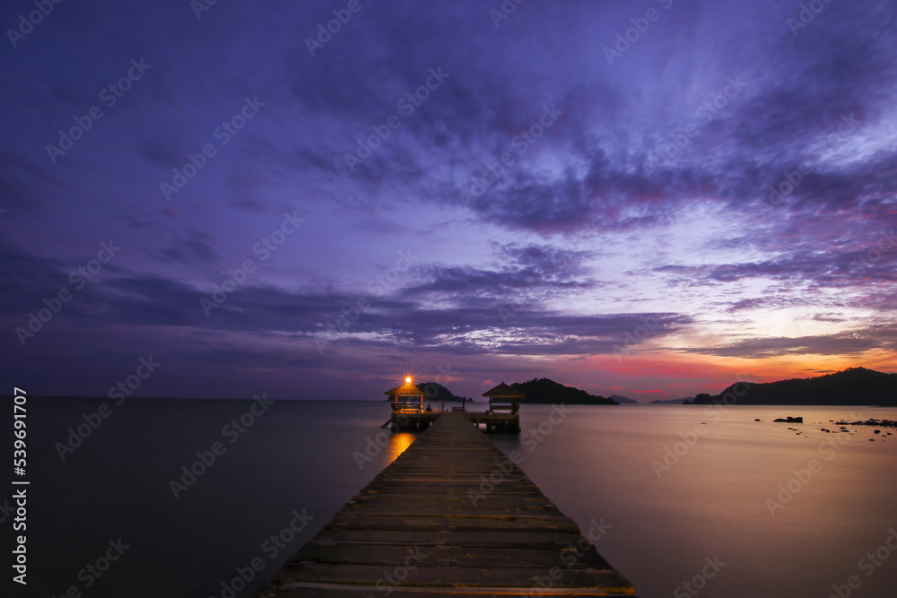Wood port pier bridge at travel island with twilight sunset cloud sky background landscape in Thailand
