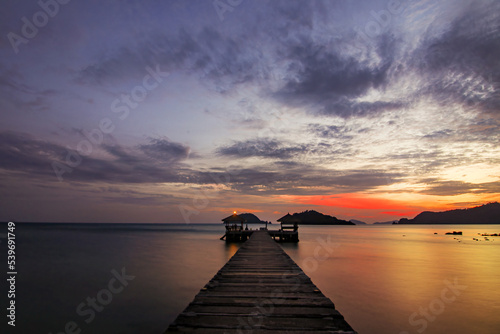 Wood port pier bridge at travel island with twilight sunset cloud sky background landscape in Thailand