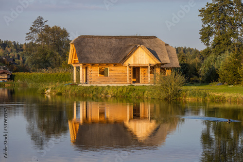 Wooden house on the lake © Tomasz