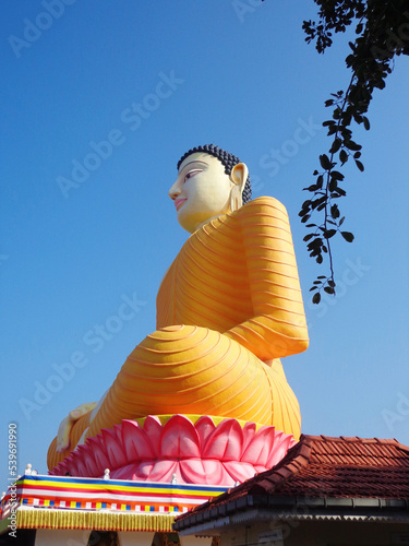 Sitting Buddha statue side view vertical Kande Viharaya Temple, Aluthgama, beruwala, Western Province, Sri Lanka photo