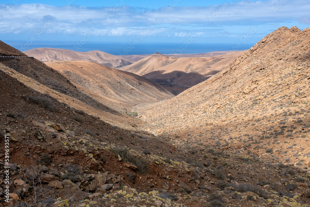 Spectacular landscape and desert of the volcanic island of Fuerteventura with the ocean in the background, Canary Islands