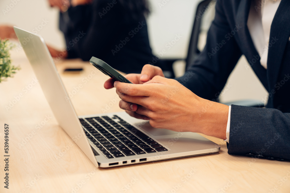 Businessman hand using laptop and smart phone working at home office. Businessman hand using laptop and smart phone working at home office.