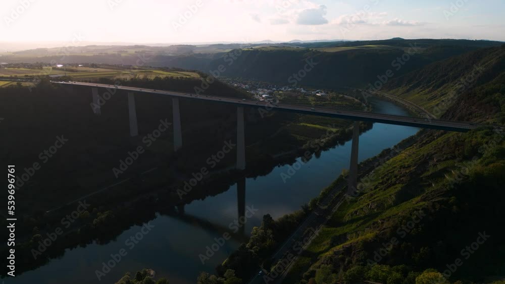 Moselle Viaduct, Winningen, Germany - romantic aerial drone flight Moseltalbrücke and highway A61 over moselle valley, bridge connecting the Eifel mountains - bird view with water reflections Moselle Viaduct, Winningen, Germany - romantic aerial drone flight Moseltalbrücke and highway A61 over moselle valley, bridge connecting the Eifel mountains - bird view with water reflections