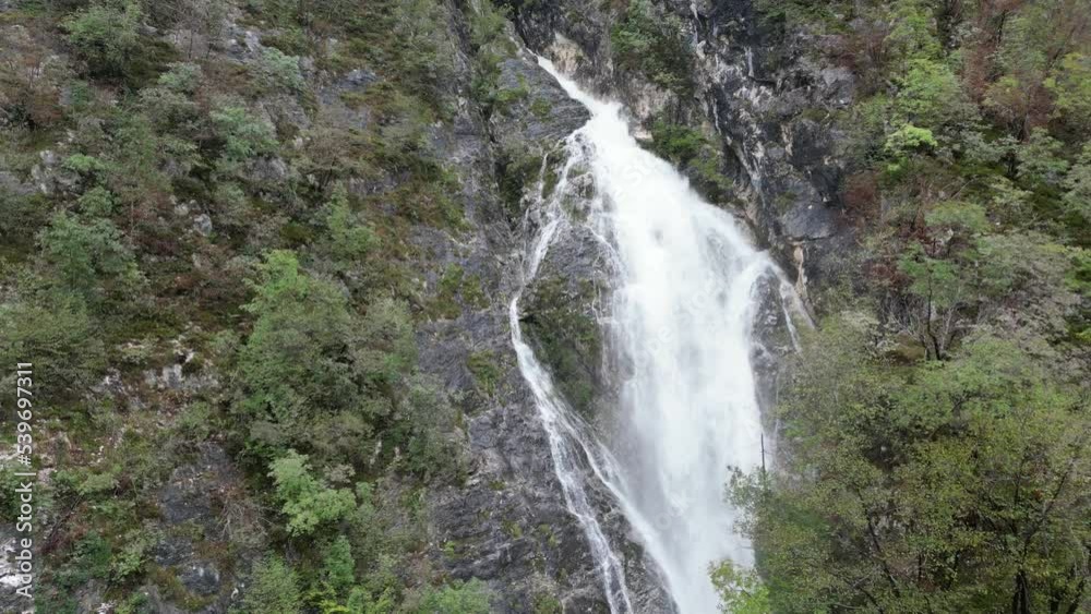 Push in shot Waterfall cascading though trees Lake Bohinj Slovenia drone aerial view Push in shot Waterfall cascading though trees Lake Bohinj Slovenia drone aerial view