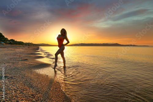 Silhouette of young woman at the sunset
