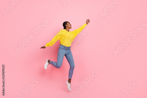 Full size profile side photo of young pretty girl jumper try to catch parasol isolated over pink color background