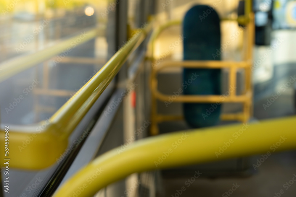 Interior of bus. Yellow handrail in transport. Public transport inside.