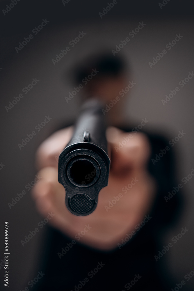 Man aiming and shooting with a gun. Focus on the pistol. Man aiming and shooting with a gun. Focus on the pistol.