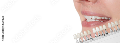 Beautiful woman smile with healthy teeth whitening. isolated on white background, Matching the shades of the implants or the process of teeth whitening. Healthy Smile. 