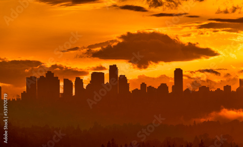 Urban cityscape silhouette on sunset sky background photo