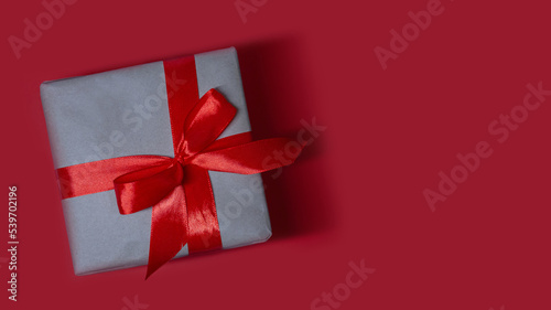 Craft gift box present gift with bright red ribbon holiday, xmas, christmas 2023. Shopping, sale banner, flyer, coupon concept with copy space