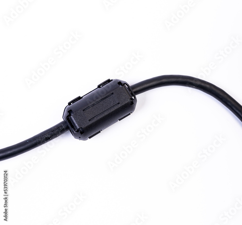 Close up of a ferrite bead inductor on cable on isolated white