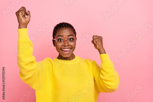 Photo of overjoyed delighted lady raise fists success achievement isolated on pink color background