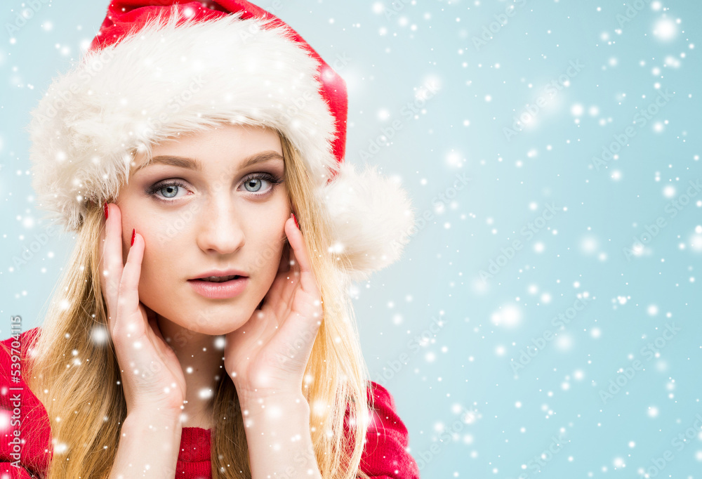 Portrait of young and pretty girl in Santa hat. New year and Christmas concept. Portrait of young and pretty girl in Santa hat. New year and Christmas concept.