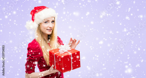Portrait of young and pretty girl in Santa hat. New year and Christmas concept.