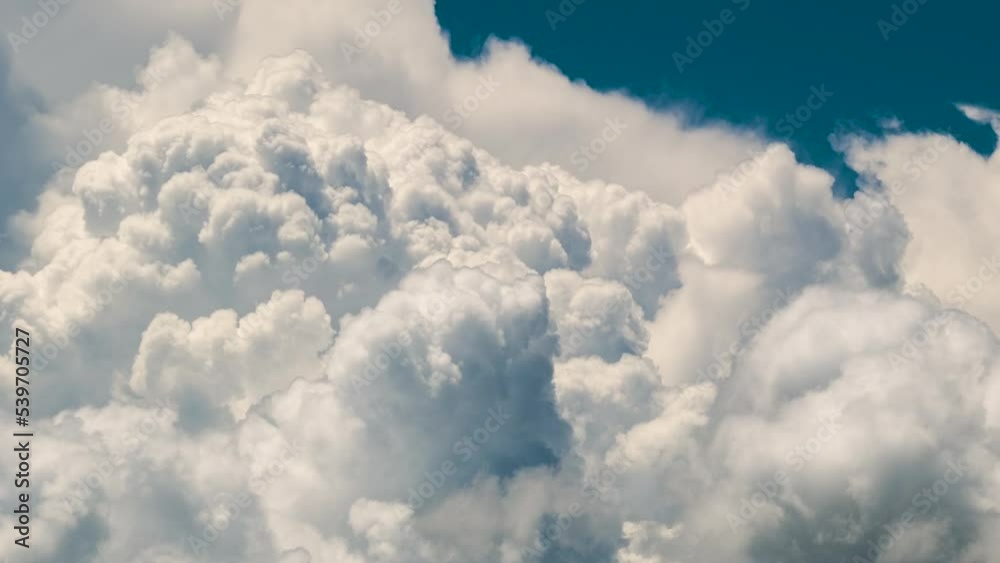 Time lapse of white fluffy cumulonimbus clouds forming before thunderstorm on summer blue sky. Moving and changing cloudscape weather